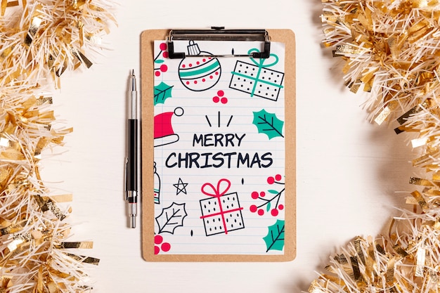 PSD merry christmas mock-up clipboard and golden tinsel