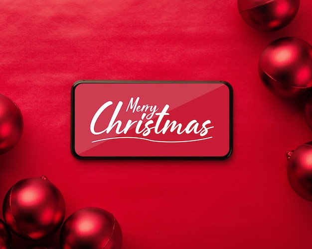 PSD mockup di smartphone di buon natale con palle di natale