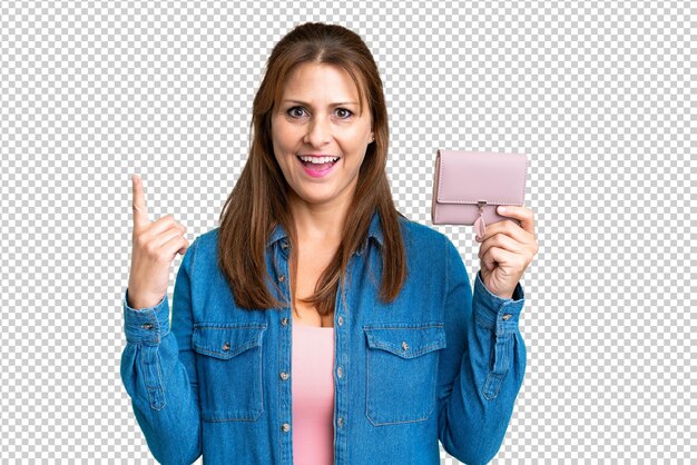 PSD middle age caucasian woman holding wallet over isolated background pointing up a great idea