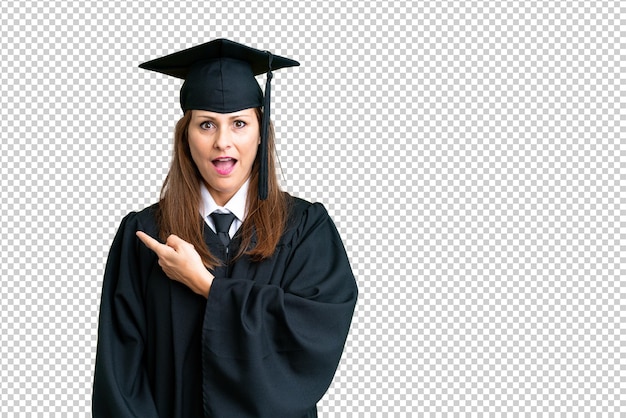 PSD middle age university graduate woman over isolated background surprised and pointing side