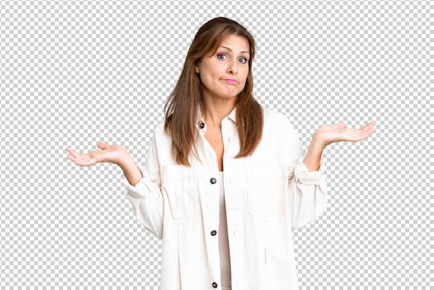 PSD middle age woman over isolated background having doubts while raising hands