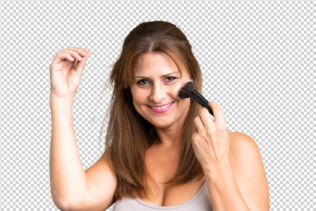 PSD middle age woman over isolated background holding makeup brush