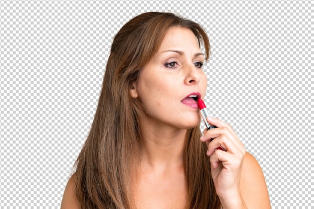 PSD middle age woman over isolated background holding red lipstick