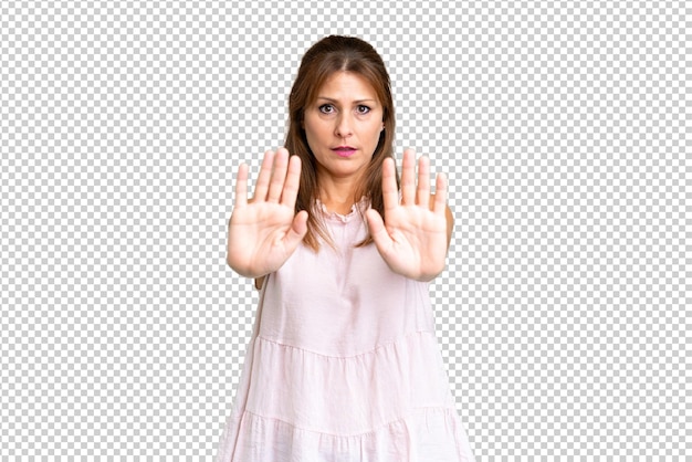 middle age woman over isolated background making stop gesture and disappointed