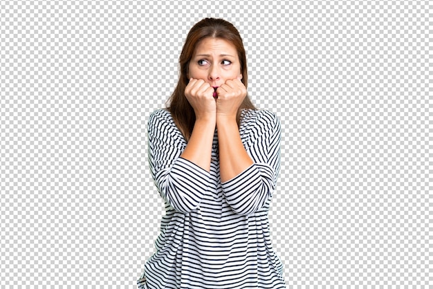 Middle age woman over isolated background nervous and scared putting hands to mouth