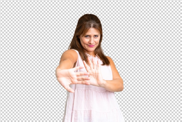PSD middle age woman over isolated background nervous stretching hands to the front