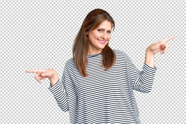 Middle age woman over isolated background pointing finger to the laterals and happy