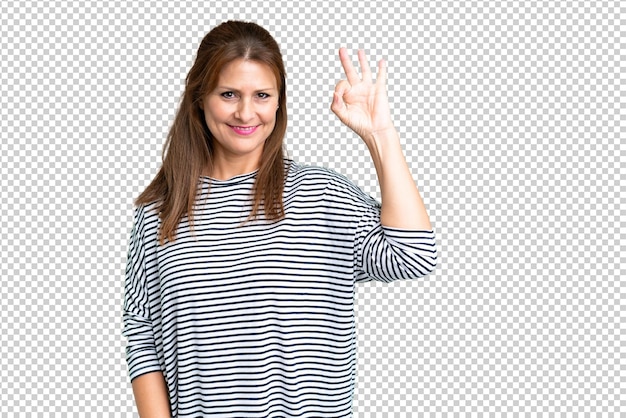 PSD middle age woman over isolated background showing ok sign with fingers