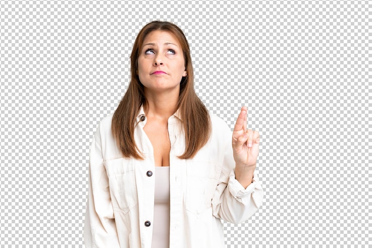 PSD middle age woman over isolated background with fingers crossing and wishing the best