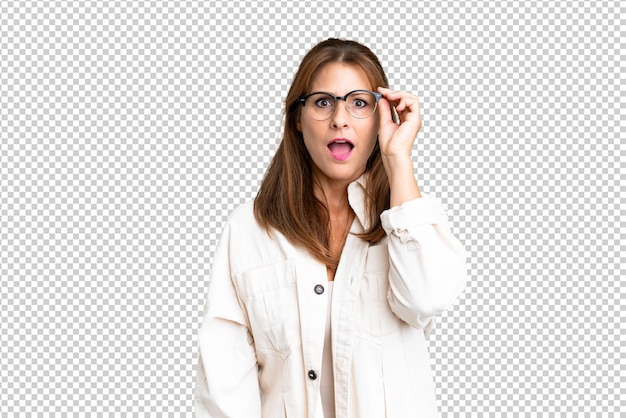 Middle age woman over isolated background with glasses and surprised