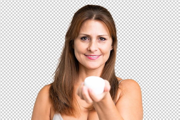 PSD middle age woman over isolated background with moisturizer and offering it