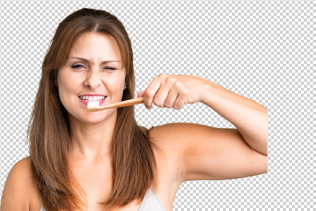 PSD middle age woman over isolated background with a toothbrush