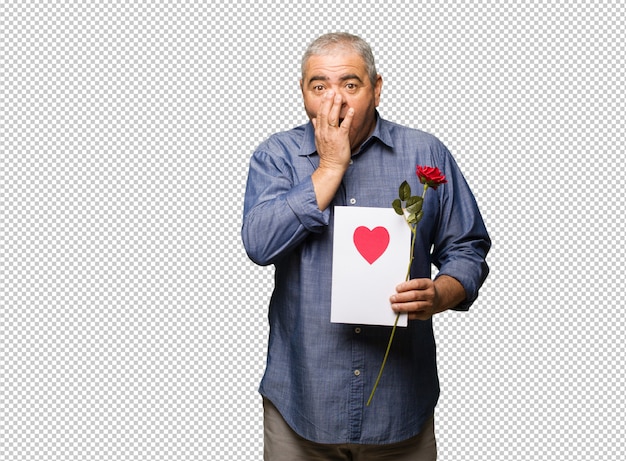 Middle aged man celebrating valentines day very scared and afraid hidden