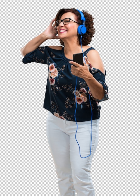 Middle aged woman happy and fun, listening to music, modern headphones, happy feeling the sound and rhythm