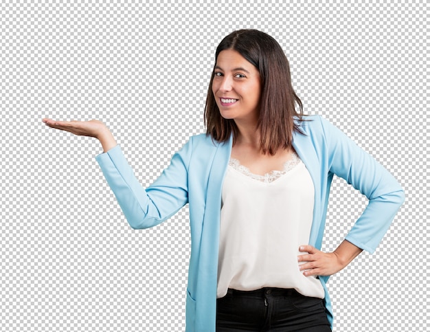 Middle aged woman holding something with hands, showing a product, smiling and cheerful