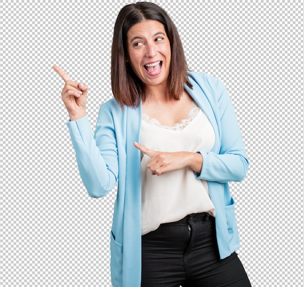 PSD middle aged woman pointing to the side, smiling surprised presenting something, natural and casual