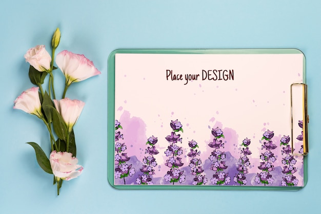 PSD minimal composition with a eustoma flowers in an envelope with clipboard on a blue paper