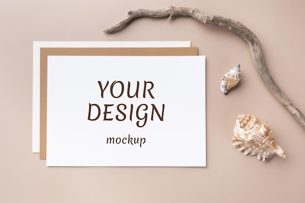 Minimal paper card mockup on beige background with branches and seashell