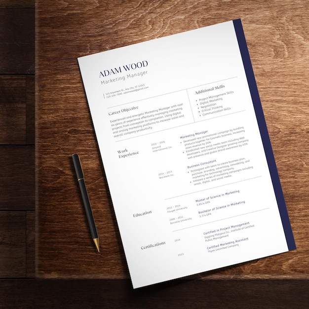 PSD minimalist clean resume template on wood surface with pen