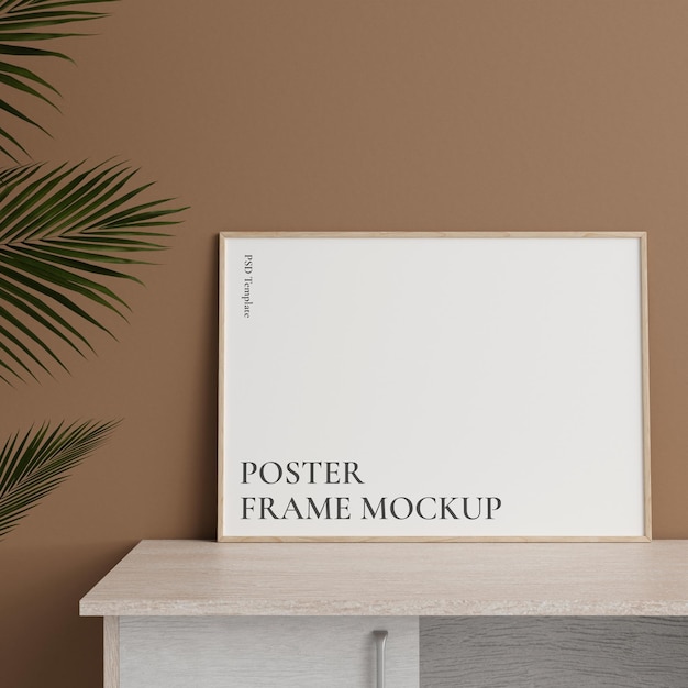 Minimalist front view horizontal wooden photo or poster frame mockup leaning against wall on table with plant 3d rendering