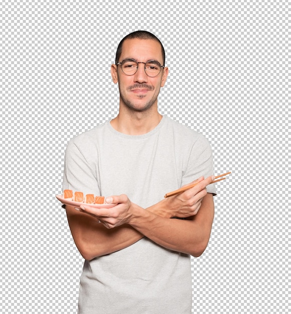 PSD młody człowiek za pomocą pałeczek do jedzenia sushi