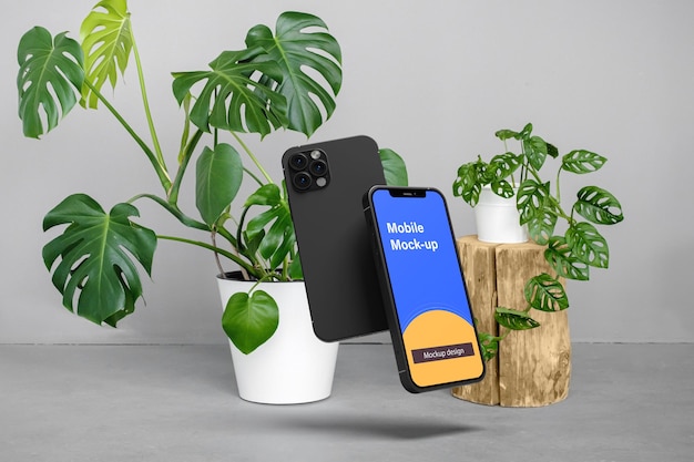 Mobile mock up design con giardino di foglie di monstera sul tavolo