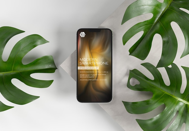 Mobile phone on concrete display with leaves mockup