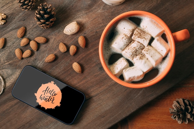 mobile phone with hello winter and delicious winter drink