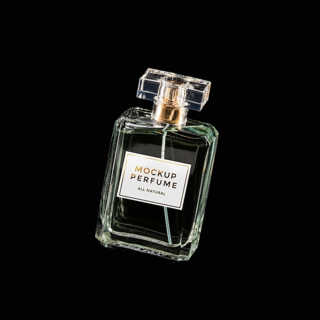 PSD mock-up of clear bottle of perfume on black background