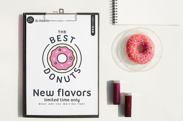 Mock-up clipboard and sweet snack on desk