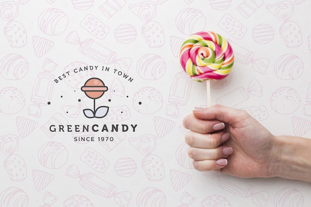 Mock-up hand with tasty lollipop