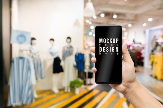 Mock up mobile phone of women clothing fashion shop.