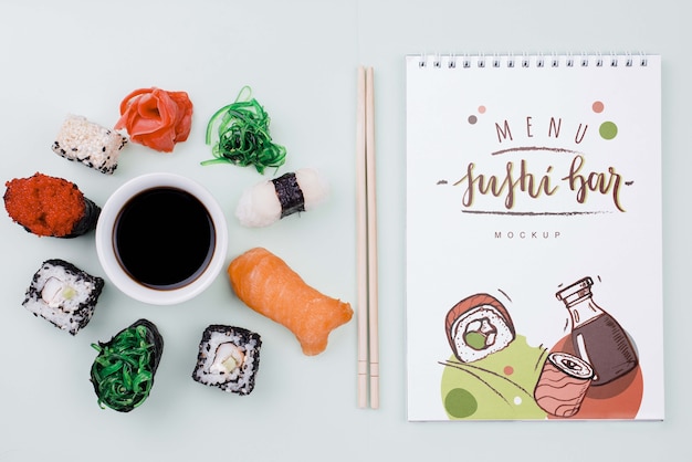 Mock-up sushi rolls with soya sauce and notebook