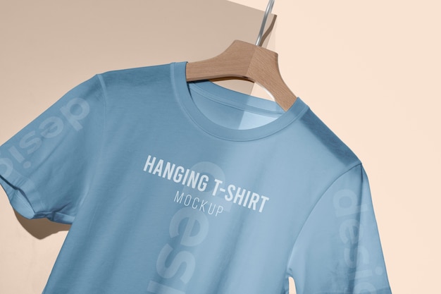 PSD mock-up t-shirt hanging on wooden hanger