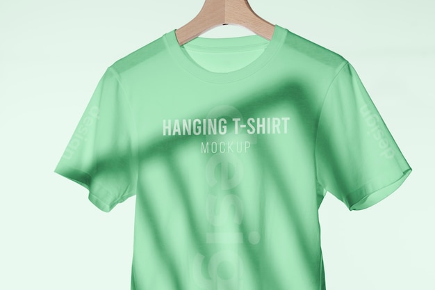 PSD mock-up t-shirt hanging on wooden hanger