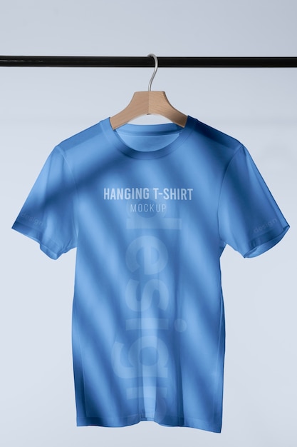 PSD mock-up t-shirt hanging on wooden hanger