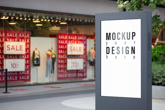 PSD mockup of advertisement lightbox with blurred fashion store