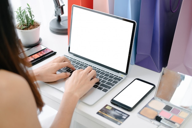 Mockup of beautiful woman shopping online with laptop and smartphone on online websites