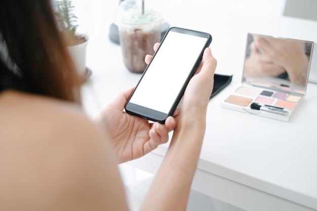 PSD mockup of beautiful woman shopping online with smartphone on online websites