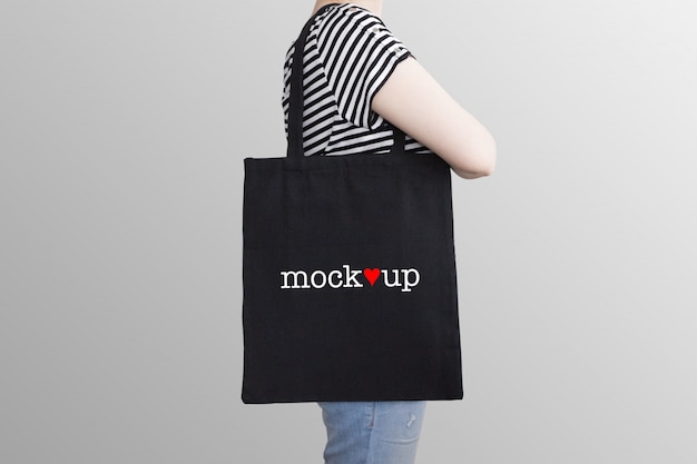 Mockup of a black tote bag on a model