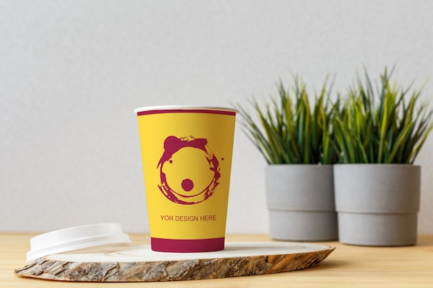 PSD mockup blank craft paper cup on the white wall background.