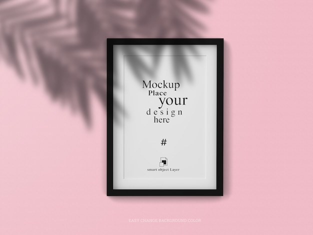 Mockup blank photo frame with shadow leaf on the wall