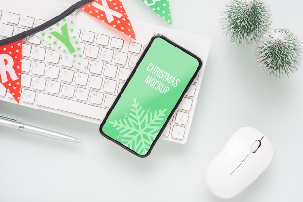 PSD mockup blank smartphone on home office for christmas and new year