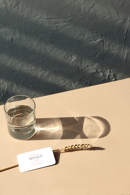 PSD mockup business cards, wheatear, glass on beige background