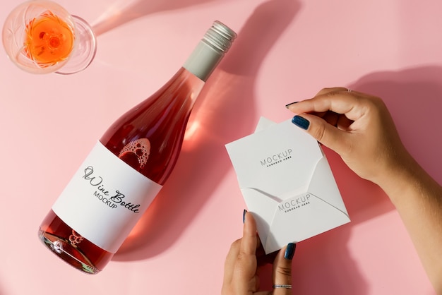 PSD mockup card in hand with  mockup wine bottle