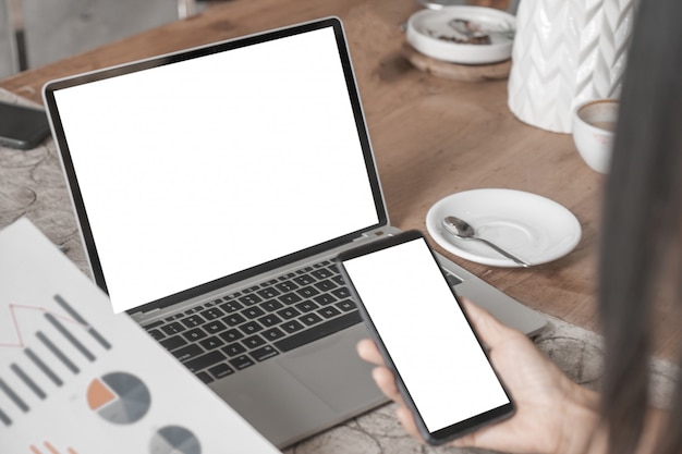 Mockup of close up business woman working with smartphone laptop and documents in office