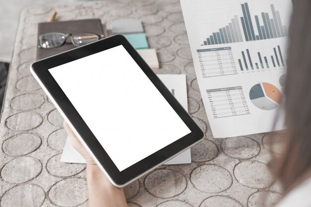 mockup of close up business woman working with tablet and documents in office