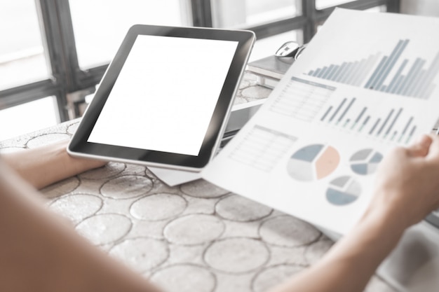 Mockup of close up business woman working with  tablet and documents in office