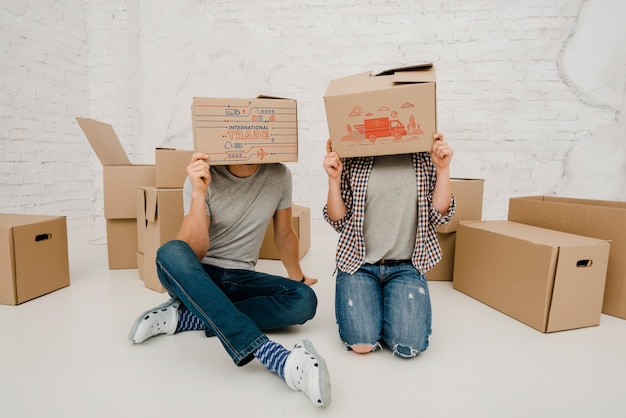 PSD mockup of couple with cardboard boxes