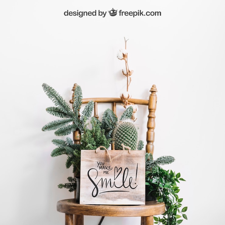 PSD mockup of frame on chair with flowers and cactus